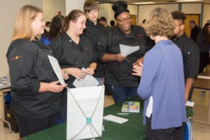 culinary arts students speak with an admissions rep from HVCC