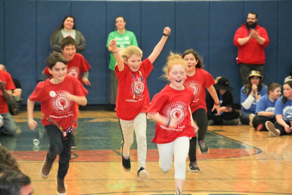 photos of four excited students going to receive their award