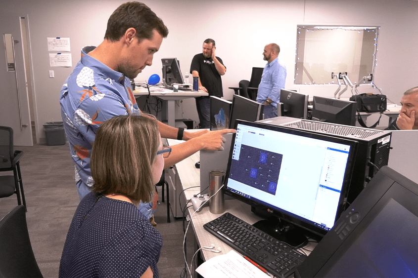 photo of two teachers working at a computer